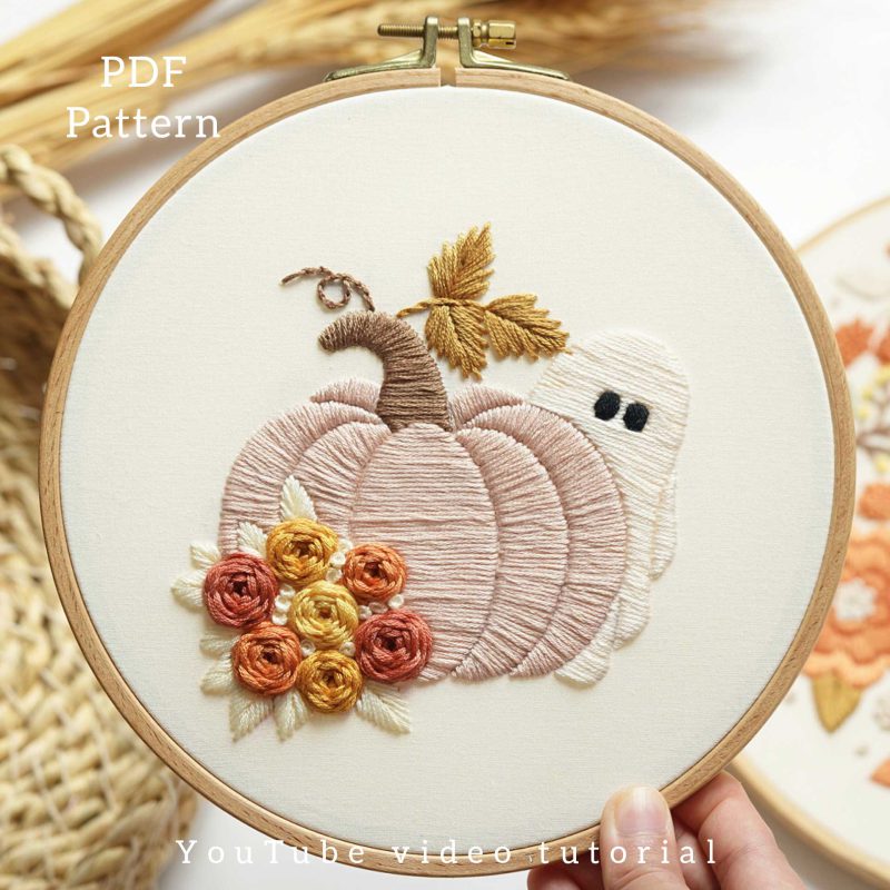 Pumpkin embroidery with a ghost hiding behind it